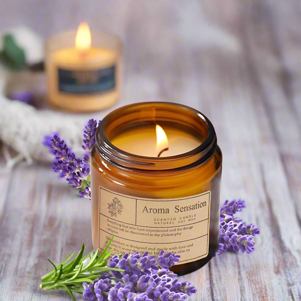 Aroma Sensation scented candle in an amber jar with lavender flowers on a white background