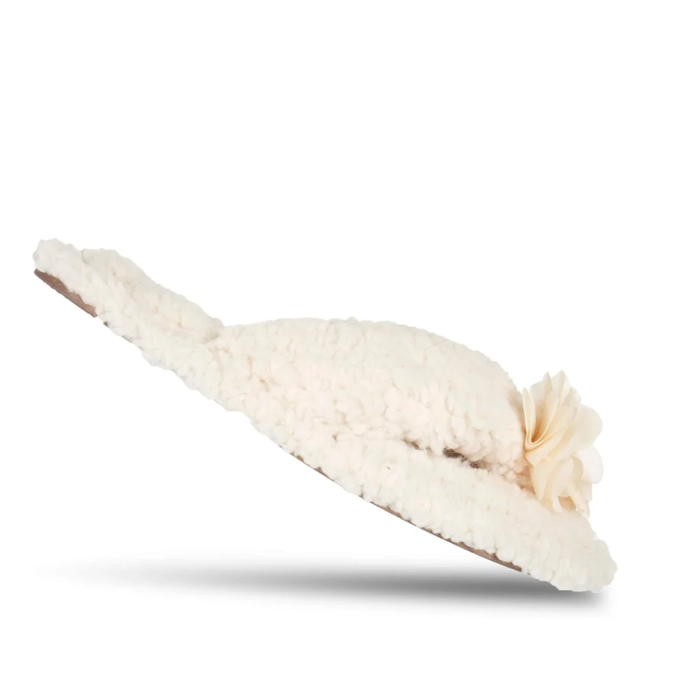 White dog toy with a flower on a white background
