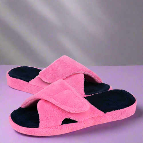 Pink slippers with black soles on a white background