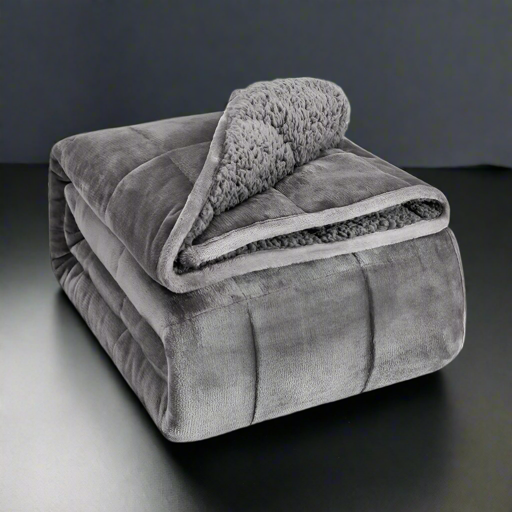 Gray blanket with sherpa interior on a white background