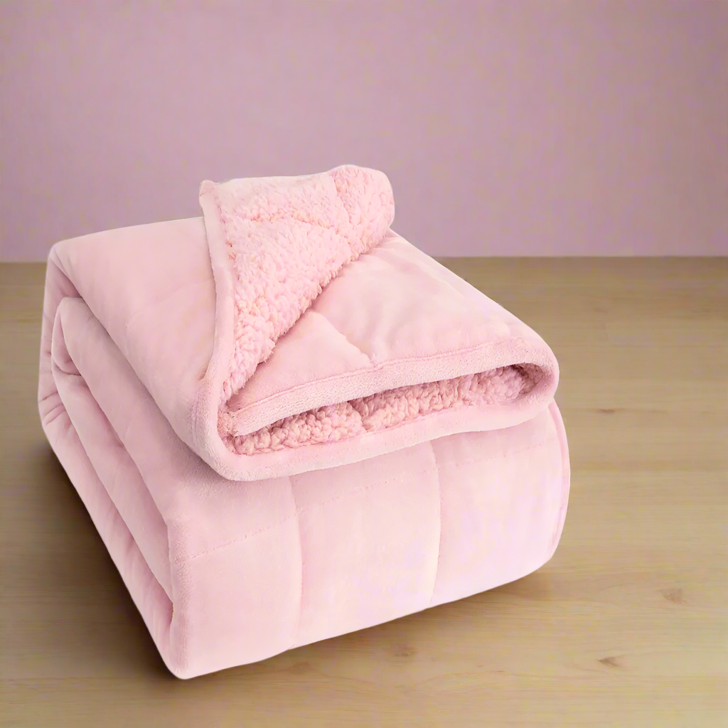 Pink sherpa blanket on a white background
